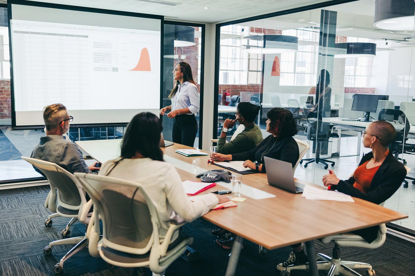 A woman giving a presentation to a group of people