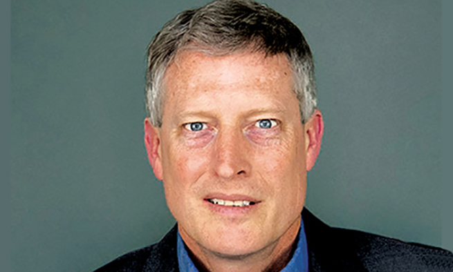 White blue eyed man looking to the camera, against grey background