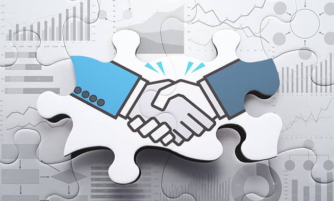 shake hands on puzzle pieces