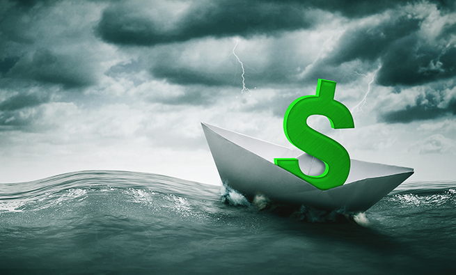 dollar sign on a paper boat on the high seas