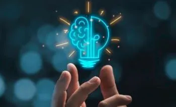 A person's hand holding a graphic of a lightbulb