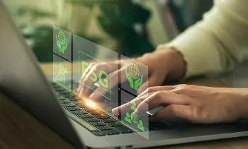 Close up shot of a person typing on computer with green ESG graphic floating above the keyboard.