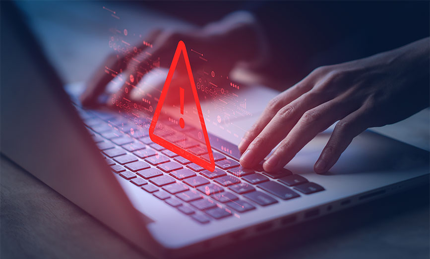 A warning symbol superimposed over a laptop keyboard